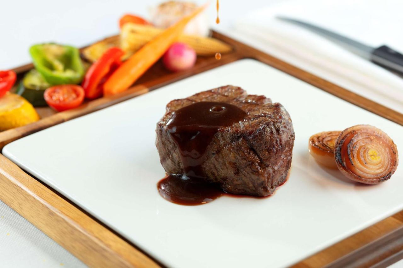 Symphony Style Hotel Kuwait Salmiya Exteriör bild A steak with sauce